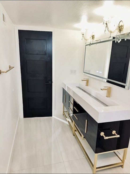 Black and gold double vanity bathroom remodel