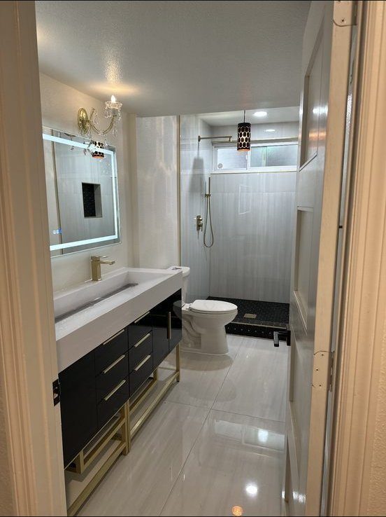 Bathroom with LED mirror, floating vanity and walk-in shower