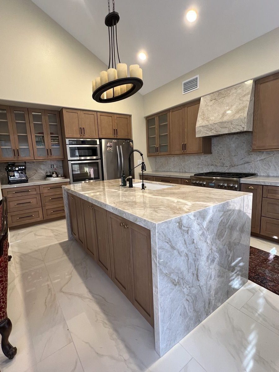 Kitchen remodel with waterfall quartzite island by Blue Diamond Construction